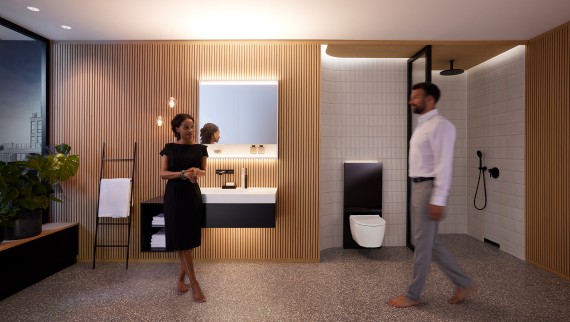 Man and woman in perfectly lit bathroom with Geberit ONE bathroom furniture and ceramic appliances (© Geberit) Man and woman in perfectly lit bathroom with Geberit ONE bathroom furniture and ceramic appliances (© Geberit)