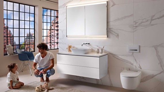 Man and child in a white bathroom from the Geberit ONE series Man and child in a white bathroom from the Geberit ONE series
