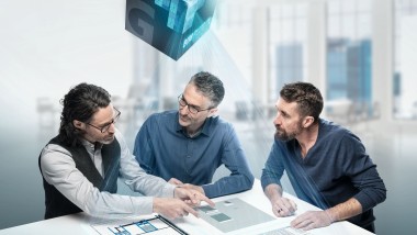 Planners deep in discussion around a table with BIM symbol