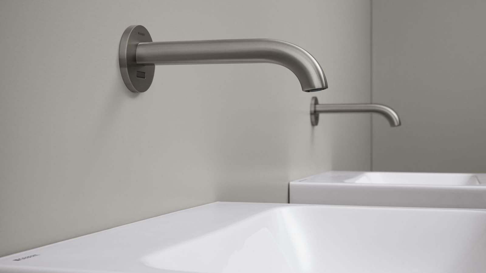 Geberit Piave wall-mounted washbasin tap in a round, brushed stainless steel design Geberit Piave wall-mounted washbasin tap in a round, brushed stainless steel design